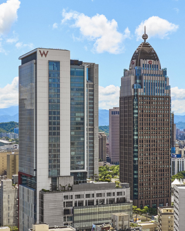 Two tall skyscrapers in an urban setting, featuring the W Hotel building on the left and the domed Uni-President International Tower on the right.